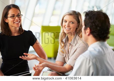 Picture or Photo of Businesspeople Having Meeting Around Table In Modern Office