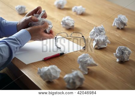 Picture or Photo of Tearing up another crumpled paper ball for the pile