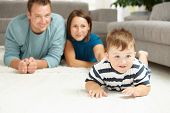 pic of interior  - Happy family lying on floor in living room - JPG 