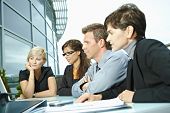 picture of business people  - Group of young business people sitting in a row at table on office terrace outdoor - JPG 