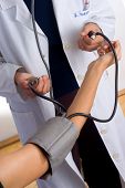 image of pressure  - female doctor is checking blood pressure - JPG 