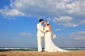 picture of blue sky  - Bride and groom by the sea on their wedding day in Greece - JPG 