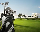 picture of golf  - golf equipment on green and hole as background - JPG 