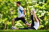 stock photo of health  - young health couple doing stretching exercise relaxing and warm up after jogging and running in park - JPG 