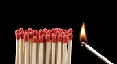 image of teamwork  - lighting matches on black background - JPG 
