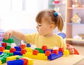 picture of preschool  - Cute little girl play with building bricks in preschool - JPG 