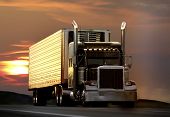 stock photo of truck  - big truck driving on a highway with sunset in background - JPG 