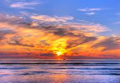stock photo of sunset  - Sunset on the beach orange blue red - JPG 