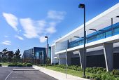 picture of industrial  - Modern industrial building on sunny day with blue sky behind - JPG 