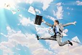 foto of businessmen  - Image of a businessman jumping high against blue sky background - JPG 