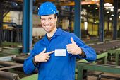 pic of construction worker  - Construction worker with helmet in assembly hall with thumbs up - JPG 