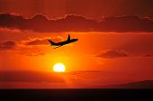 picture of sunset  - An Airliner Flying Into A Beautiful Tropical Sunset - JPG 