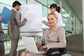 picture of business people  - Businesswoman sitting in a wheelchair during a presentation - JPG 