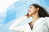 stock photo of leadership  - beautiful business woman on the phone at modern building - JPG 