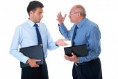 picture of teamwork  - young and older businessman have argument over their work - JPG 