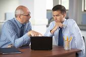 image of meeting  - senior and junior businessman discuss something during their meeting - JPG 