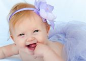 picture of infants  - Portrait of a beautiful baby girl wearing a purpule ballet tutu - JPG 