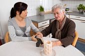 stock photo of comfort  - a young woman comforting a widow after death - JPG 