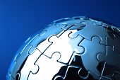 stock photo of puzzle  - Globe puzzle concept for business solutions and strategy on blue background - JPG 