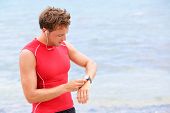 foto of watch  - Athlete runner looking at heart rate monitor watch - JPG 