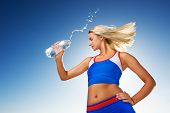 pic of fitness  - Young woman drinking water after fitness exercise - JPG 