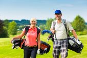 pic of golf  - Young sportive couple playing golf on a golf course - JPG 