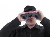 stock photo of security  - Security man wearing black uniform looking through binocular - JPG 
