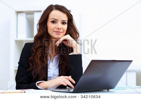 Picture or Photo of Young pretty business woman with notebook in the office