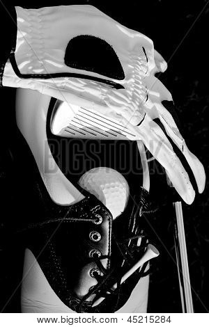 Picture or Photo of Golf equipment including golf club, golf ball, golf shoes, golf tee and golf gloves in a black and white still life