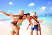 foto of holidays  - Family of four having fun at the beach - JPG 