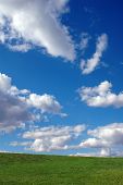 image of blue sky  - Blue sky with clouds and green grass - JPG 