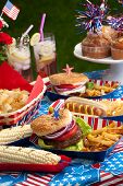 pic of food  - Hot dogs corn and burgers on 4th of July picnic in patriotic theme - JPG 
