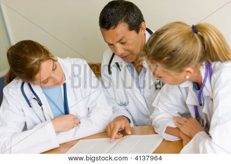 Picture or Photo of Small group of doctors in a meeting discussing a medical history