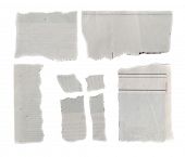 stock photo of newsprint  - Pieces of torn paper on plain background - JPG 