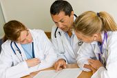 image of meeting  - small group of doctors in a meeting discussing a medical history - JPG 