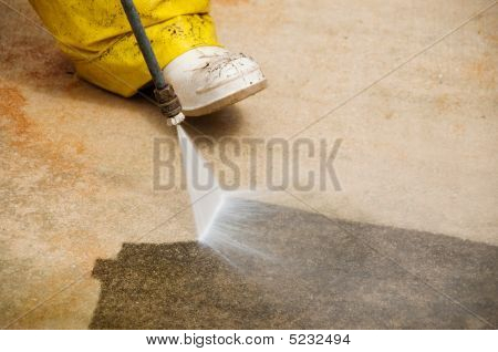 Picture or Photo of Maintenance worker cleaning old dirty driveway with a pressure cleaner