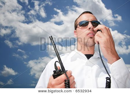 Picture or Photo of Security guard using hand-held radio for communication