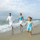 image of family  - Happy family playing on the beach - JPG 