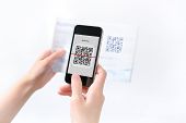 stock photo of code  - Woman scanning QR code in the magazine on mobile smart phone - JPG 