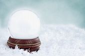 stock photo of globe  - Blank snow globe with with copy space available against a blue background - JPG 