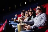 stock photo of watch  - Young attractive people watch movies in cinema - JPG 