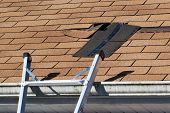 stock photo of leak  - Fixing damaged roof shingles - JPG 