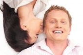 stock photo of young adult  - Young happy couple kissing over white background - JPG 