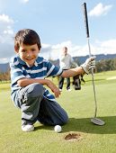image of golf  - Young boy playing golf at the club - JPG 
