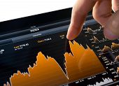 image of stock  - Touching stock market graph on a touch screen device - JPG 