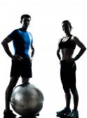 stock photo of fitness  - one caucasian couple man woman personal trainer coach exercising fitness ball silhouette studio isolated on white background - JPG 