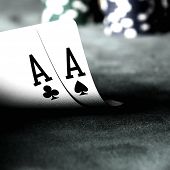 pic of competition  - two aces on green table with blurry chips and background - JPG 
