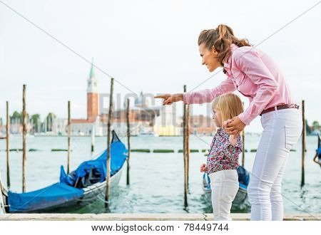 Poster: Mother Pointing Baby On Something