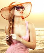 picture of woman  - Portrait of a beautiful woman in glasses  on the beach - JPG 