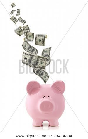Picture or Photo of Us currency falling into a pink piggy bank, isolated on white.